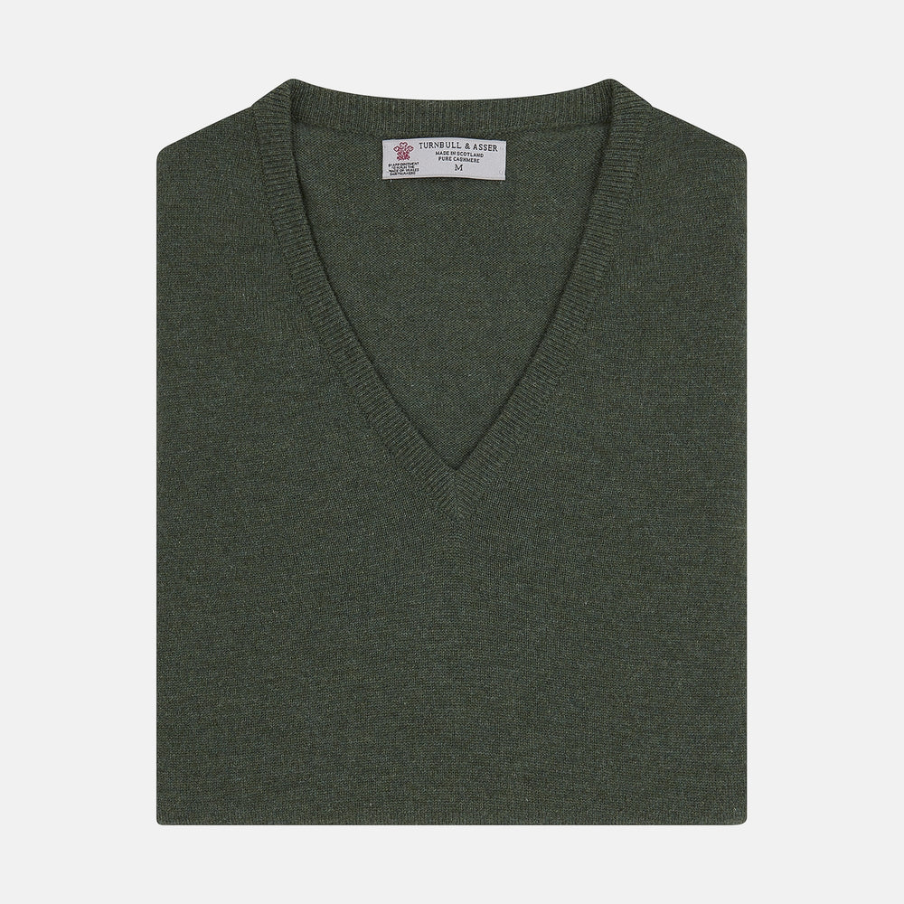 The Turnbull & Asser Green V-Neck Cashmere Slipover is neatly folded with the brand and size tag visible, displayed flat on a plain white background.