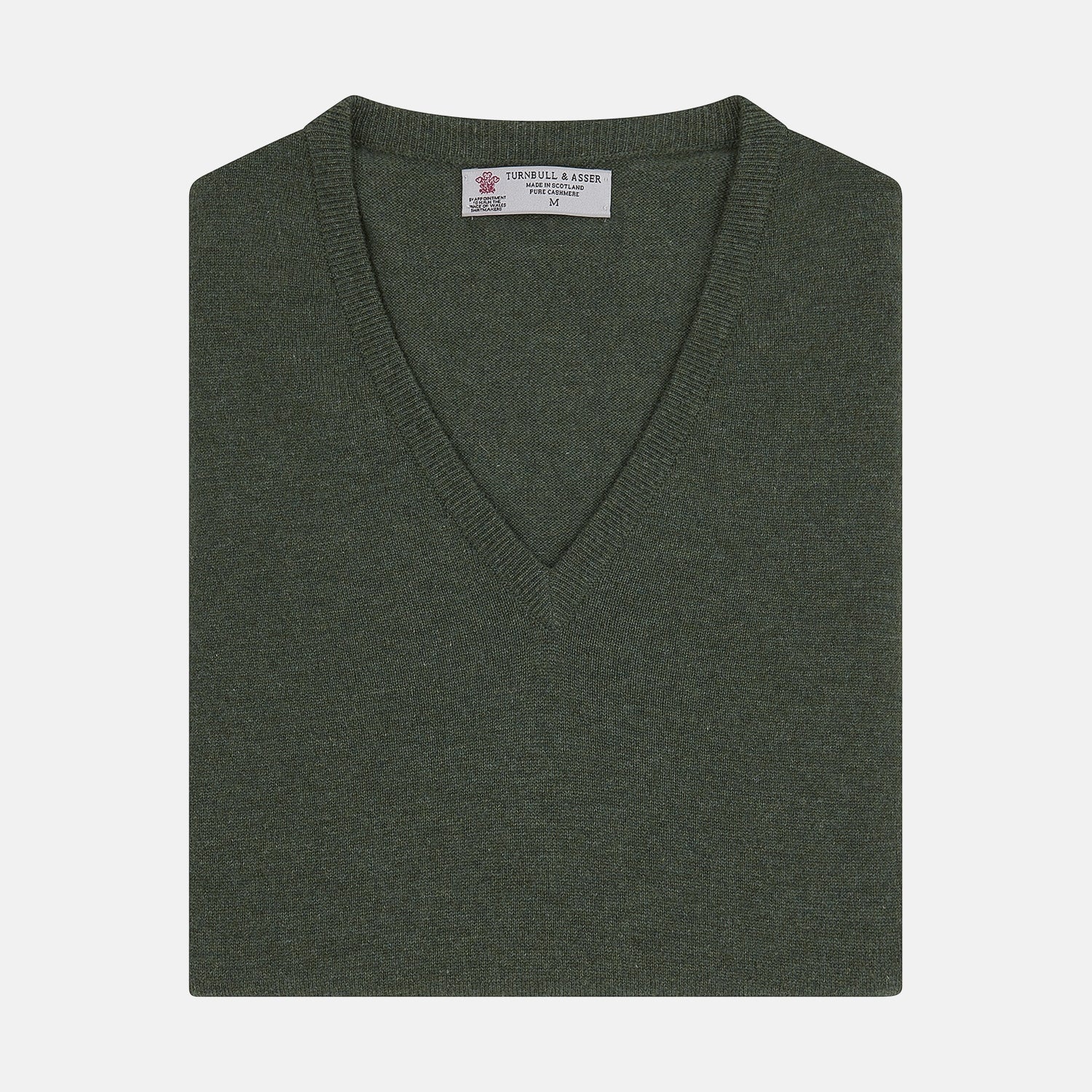 View 1 of product The Turnbull & Asser Green V-Neck Cashmere Slipover is neatly folded with the brand and size tag visible, displayed flat on a plain white background.