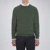 View 2 of product The Turnbull & Asser Green Crew Neck Cashmere Jumper, crafted from luxurious Scottish cashmere with ribbed cuffs, is neatly folded and displayed on a plain white background with the brand label visible inside the neckline.
