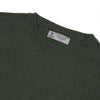 View 4 of product The Turnbull & Asser Green Crew Neck Cashmere Jumper, crafted from luxurious Scottish cashmere with ribbed cuffs, is neatly folded and displayed on a plain white background with the brand label visible inside the neckline.