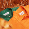 View 5 of product The Turnbull & Asser Orange Weekend Fit Long Sleeve Linen Shirt features a Derby collar, 1-button cuffs, white buttons, and a relaxed fit, shown against a white background.
