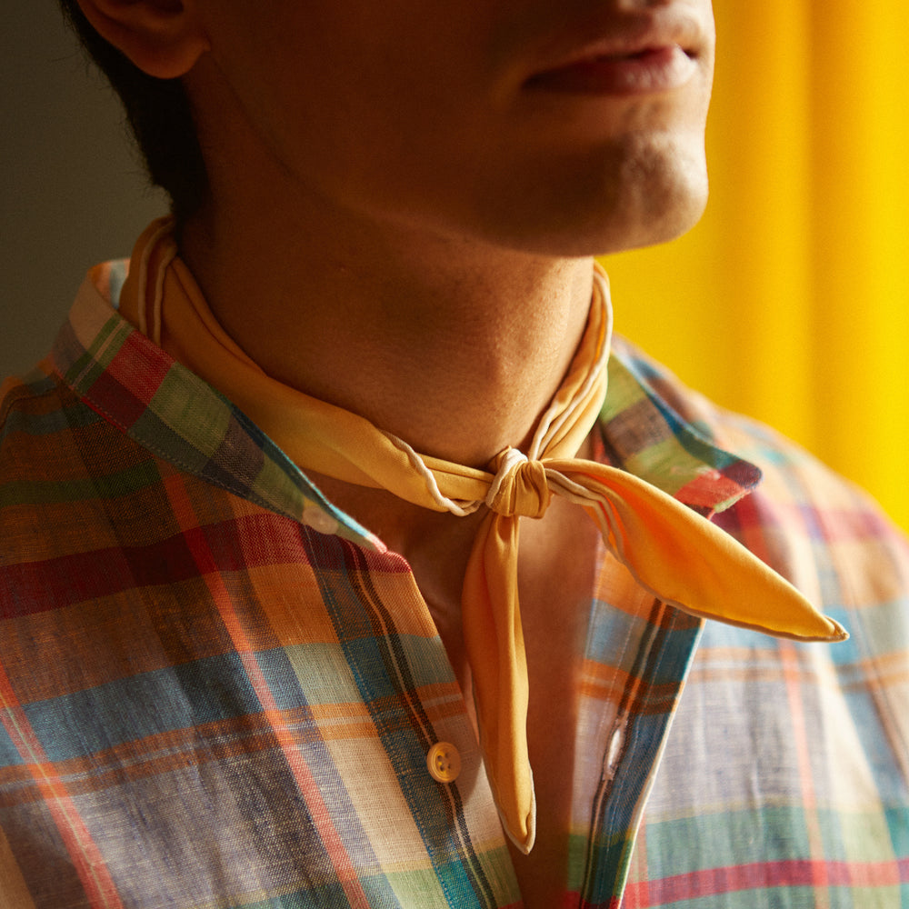 The Turnbull & Asser Red and Teal Madras Check Weekend Fit Linen Shirt features a stand collar, 1-button cuff, and colorful plaid pattern, shown against a white background.