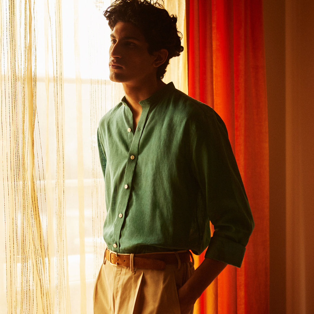 The Turnbull & Asser Teal Weekend Fit Long Sleeve Linen Shirt features a stand collar, 1-button cuffs, white buttons, and a relaxed fit, shown on a plain white background.