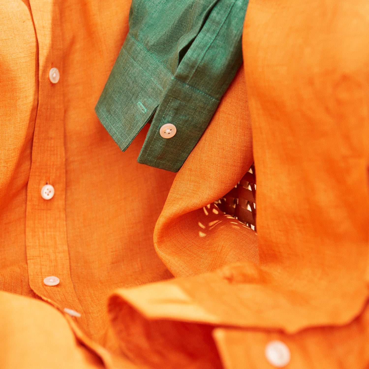 View 6 of product The Turnbull & Asser Orange Weekend Fit Long Sleeve Linen Shirt features a Derby collar, 1-button cuffs, white buttons, and a relaxed fit, shown against a white background.
