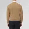 View 3 of product A folded Natural Crew Neck Cashmere Jumper by Turnbull & Asser, in light brown, features a visible brand label and one sleeve neatly laid across the front of this smart casual luxury Scottish sweater.