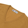 View 3 of product The Sunflower Yellow V-Neck Cashmere Slipover by Turnbull & Asser is neatly folded on a white background, showing the front and label—ideal for formal layering or as a versatile cashmere addition to your wardrobe.