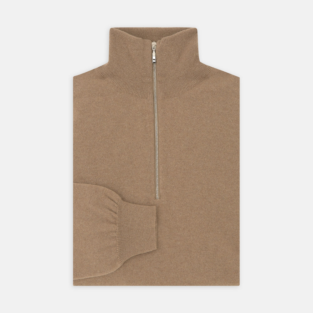 The Turnbull & Asser Natural Half-Zip Cashmere Jumper, light brown with a high collar and silver zip, is folded neatly against a white background. One sleeve shows its ribbed cuff—ideal for stylish layering.
