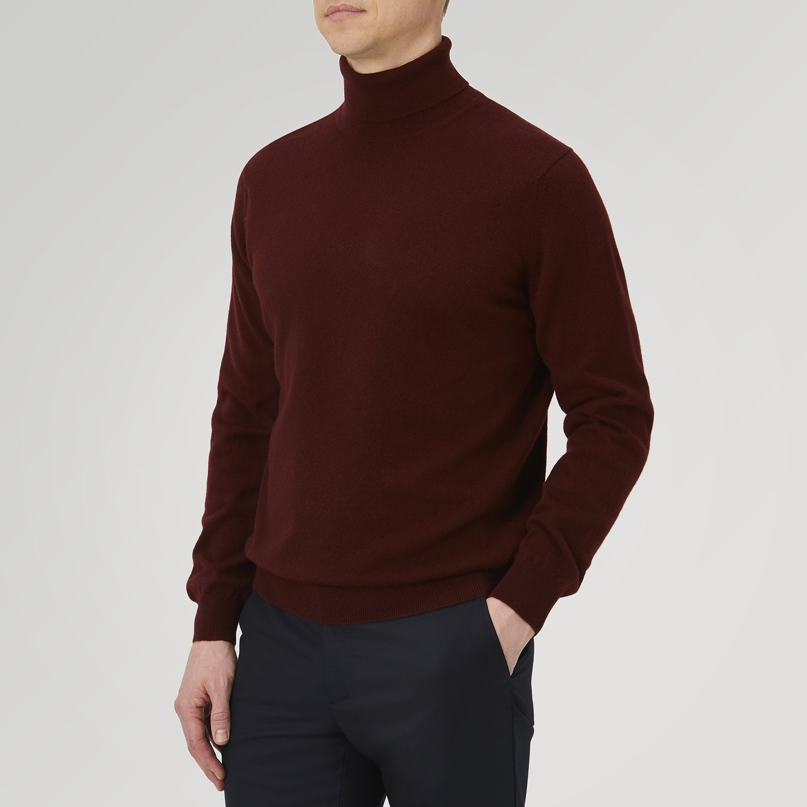 View 4 of product A folded, long-sleeve Port Cashmere Roll Neck Jumper by Turnbull & Asser in burgundy is displayed on a white background, highlighting this stylish men's autumn piece.