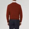 View 3 of product The Harissa Cashmere Cardigan by Turnbull & Asser, in deep red-brown 21GG knit, is folded to display its V-neck, ribbed cuffs, and two buttons against a white background.