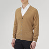 View 4 of product A Natural Cashmere Cardigan by Turnbull & Asser, light brown with a V-neckline, ribbed cuffs, and button closure, is neatly folded and displayed against a white background.