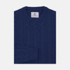 View 1 of product The Blue Crew Neck Cable Knit Cashmere Jumper by Turnbull & Asser features a chunky cable knit, ribbed crew neck and cuffs, and a visible label inside the collar.