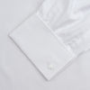 View 4 of product The Turnbull & Asser White Superfine Oxford Cotton Shirt features a T&A collar, double cuffs, and a left chest pocket. Displayed on a light gray background, it includes a visible label inside the collar—ideal for smart evening wear.