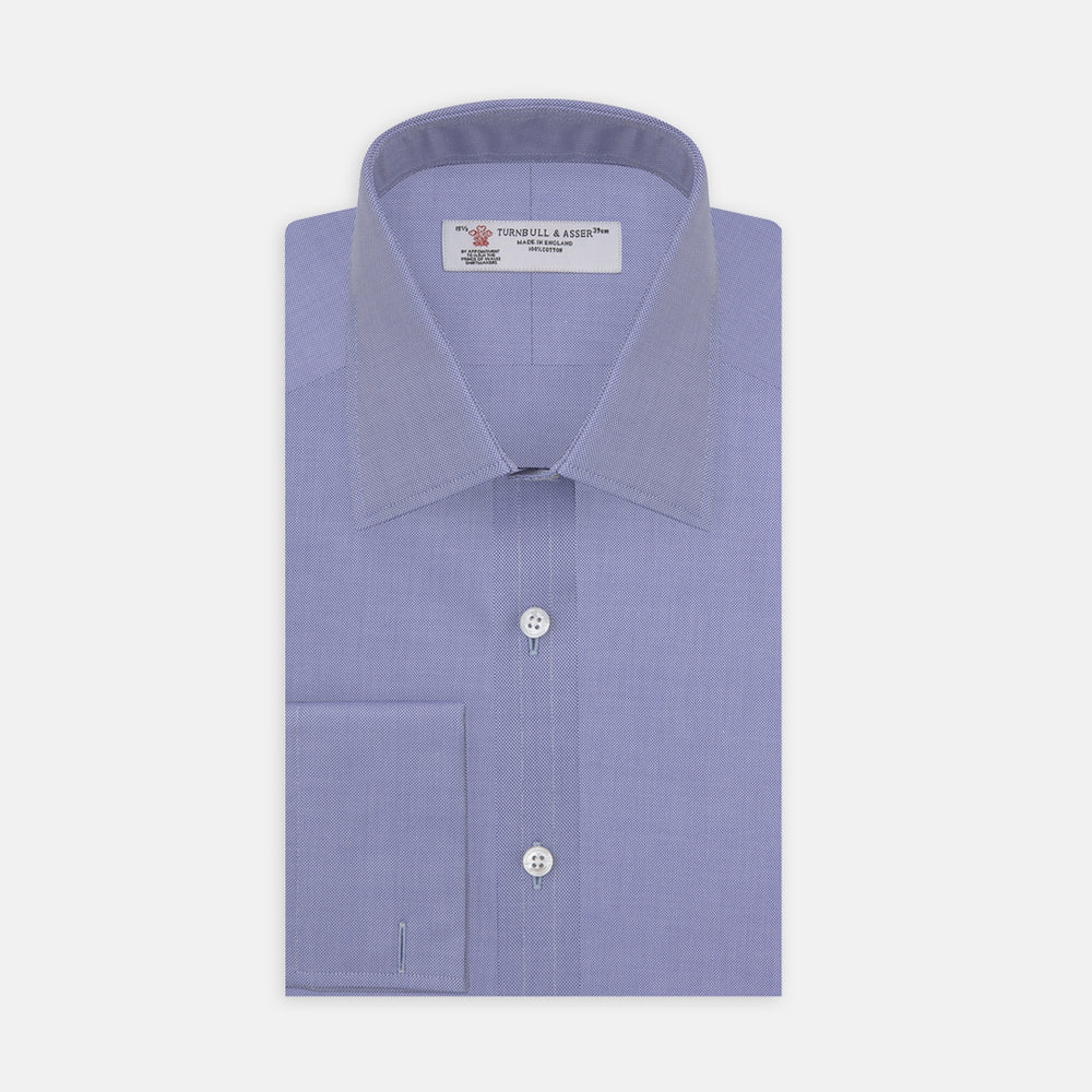 A Pink Superfine Oxford Cotton Shirt by Turnbull & Asser, featuring a T&A collar, double cuffs, and white buttons, is neatly folded and displayed against a plain white background.