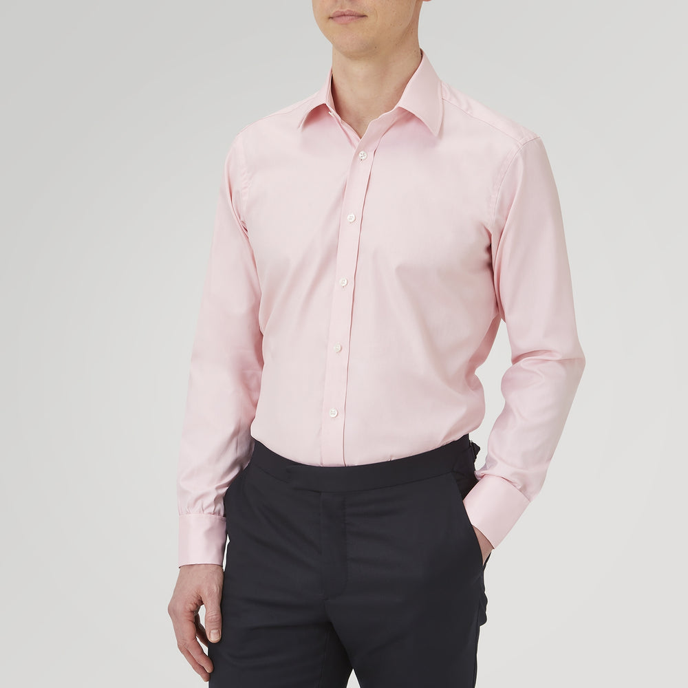 The Turnbull & Asser Pink Superfine Oxford Cotton Shirt features a T&A collar, double cuffs, and white buttons, neatly folded against a plain white background.