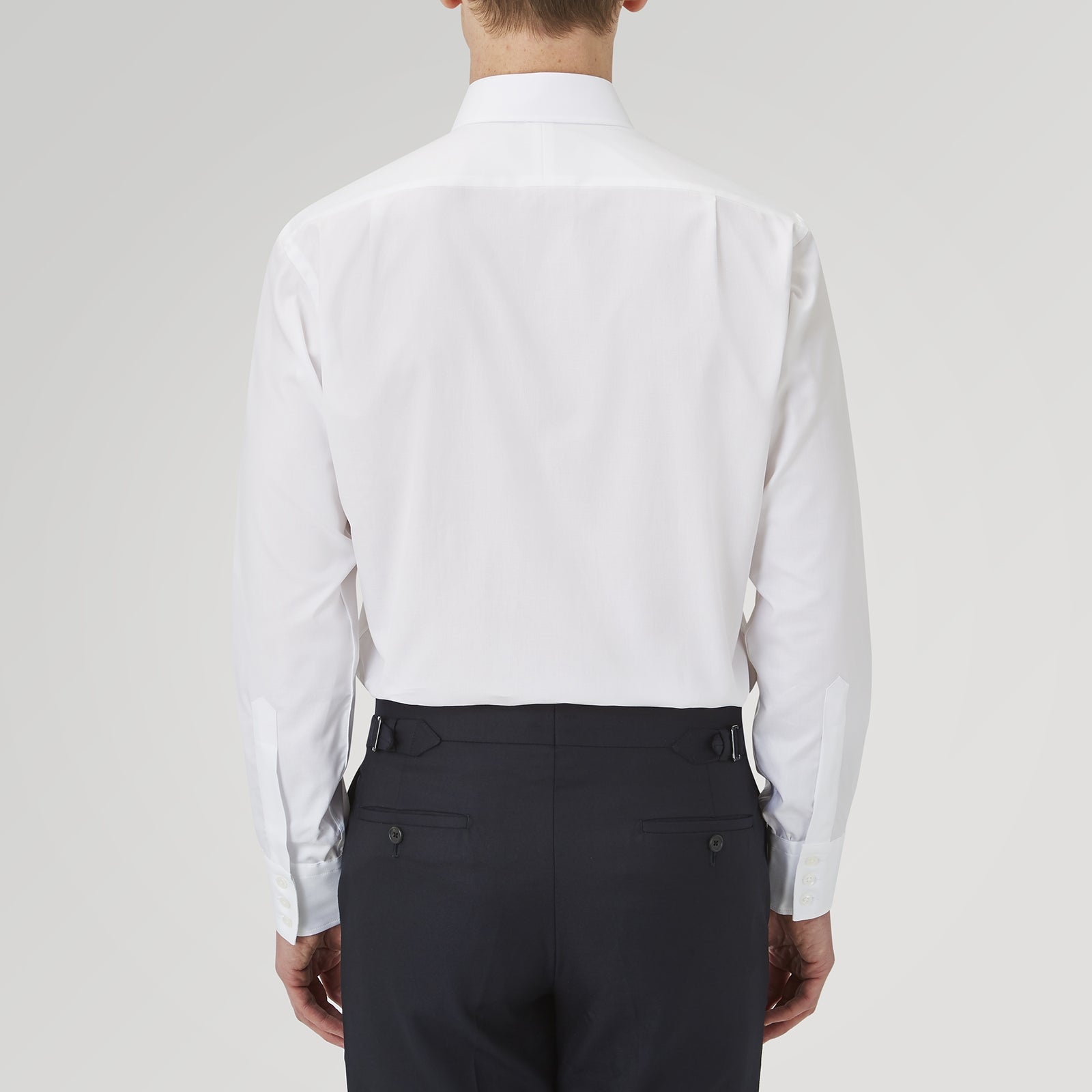 View 3 of product The Turnbull & Asser White Superfine Oxford Cotton Shirt features a T&A collar and 3-button cuffs, elegantly displayed against a light grey background.