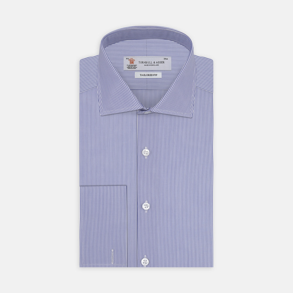 The Turnbull & Asser Tailored Fit Blue Fine Bengal Stripe Cotton Shirt features a Kent collar, double cuffs, and thin white stripes. Displayed neatly folded against a white background.