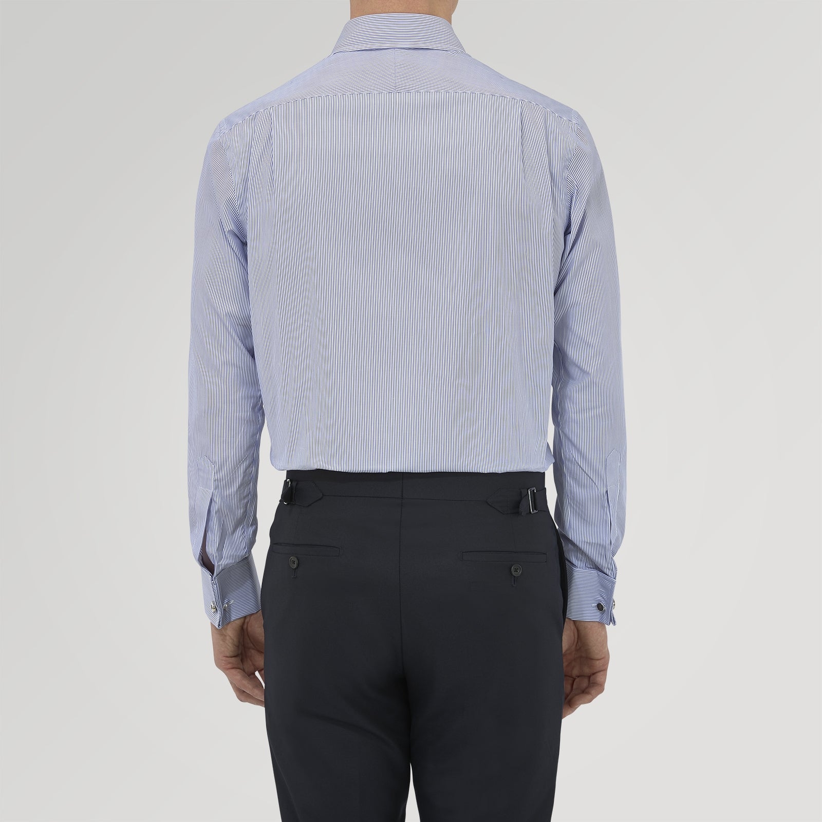 View 3 of product The Turnbull & Asser Tailored Fit Blue Fine Bengal Stripe Cotton Shirt features a Kent collar, double cuffs, and thin white stripes. Displayed neatly folded against a white background.