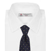 View 2 of product The Turnbull & Asser Navy and Gold Spot Lace Silk Tie, ideal for office wear, is shown rolled up on a white background.