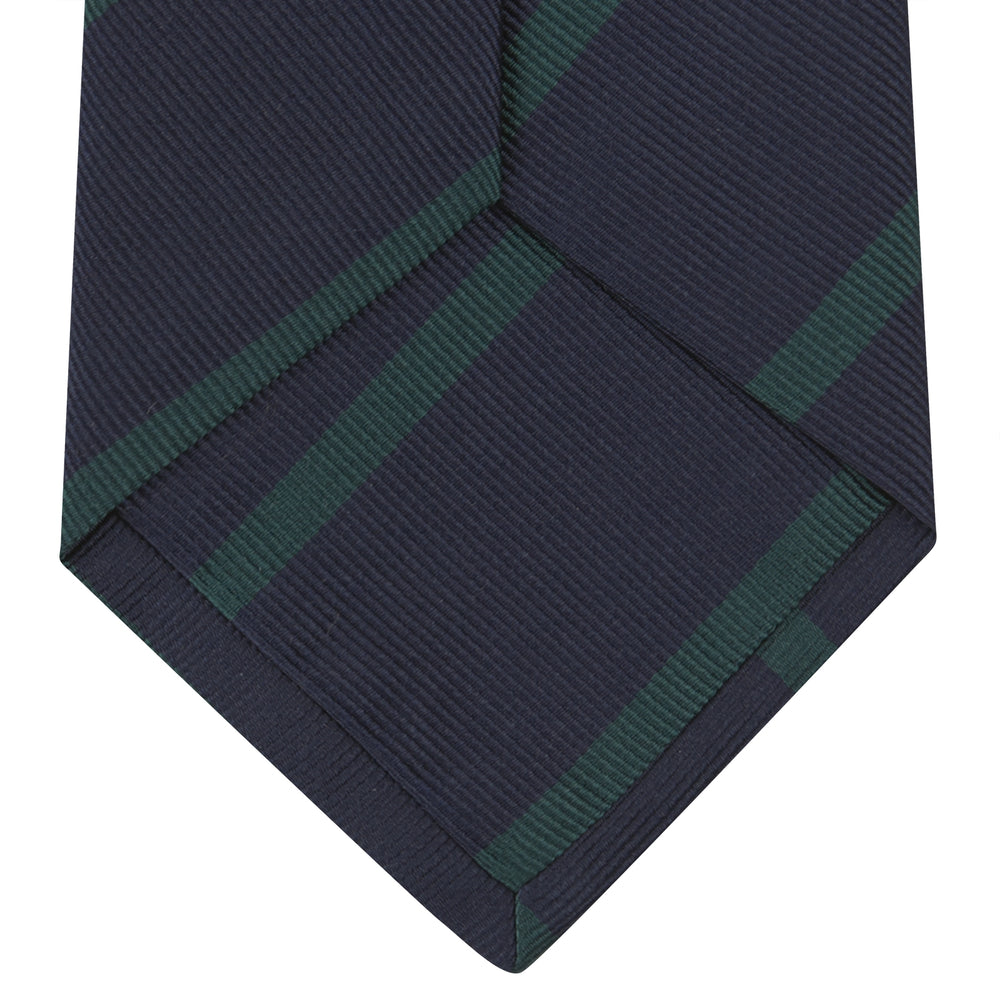 The Turnbull & Asser Navy and Green Blazer Stripe Repp Silk Tie features diagonal green stripes on navy silk, shown rolled at one end against a white background.