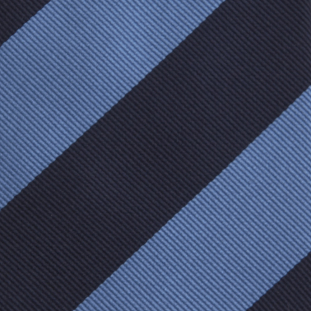 The Turnbull & Asser Navy and Blue Block Stripe Repp Silk Tie features wide navy and blue diagonal stripes on luxurious textured silk, elegantly presented against a white background.