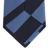 View 4 of product The Turnbull & Asser Navy and Blue Block Stripe Repp Silk Tie features wide navy and blue diagonal stripes on luxurious textured silk, elegantly presented against a white background.