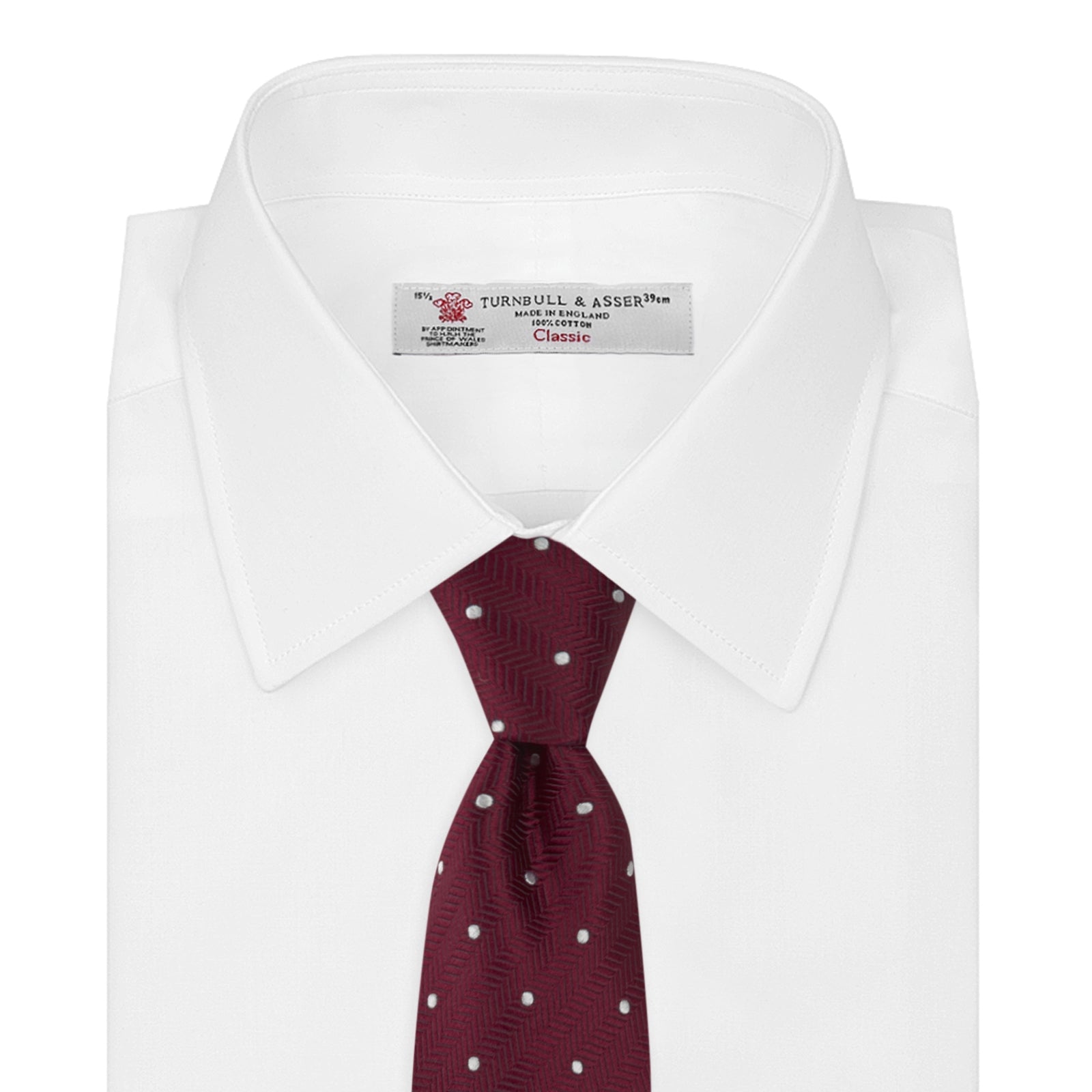 View 2 of product The Turnbull & Asser Burgundy and White Small Spot Herringbone Silk Tie, crafted from fine English silk, is shown rolled up on a plain white background.