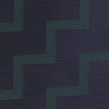 View 3 of product A modern essential, the Turnbull & Asser Navy and Forest Green Striped Zigzag Silk Tie features a bold navy and forest green zigzag pattern, elegantly displayed rolled on a crisp white background.