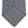 View 4 of product The Gold and Blue Circle and Spot Silk Tie by Turnbull & Asser features blue silk adorned with yellow and white circles and lines, rolled neatly on a light background—an elegant choice for complementing any office shirt.