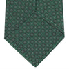 View 4 of product The Turnbull & Asser Green Floral Spot Silk Tie features small, light-colored circular dots on a classic green silk background—ideal for dressing up your favorite office shirt. Displayed rolled on a plain white backdrop.
