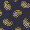 View 3 of product The Turnbull & Asser Navy and Gold Floating Paisley Silk Tie features a repeating yellow and white paisley pattern, shown rolled with the pointed end facing forward against a white background.