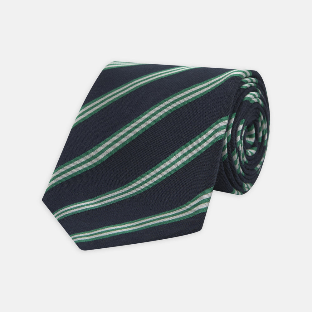 The Turnbull & Asser Navy, Green and White Multi Repp Stripe Silk Tie features elegant diagonal stripes, making it a classic accessory for any occasion. Shown rolled on a white background.