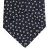 View 4 of product The Turnbull & Asser Navy and White Paint Spot Silk Tie features evenly spaced white spots on classic navy, shown rolled up on a white background—ideal for complementing your favorite office shirt.