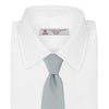 View 2 of product A neatly rolled Turnbull & Asser Light Blue Grenadine Silk Tie, featuring a subtle textured weave, displayed on a white background.