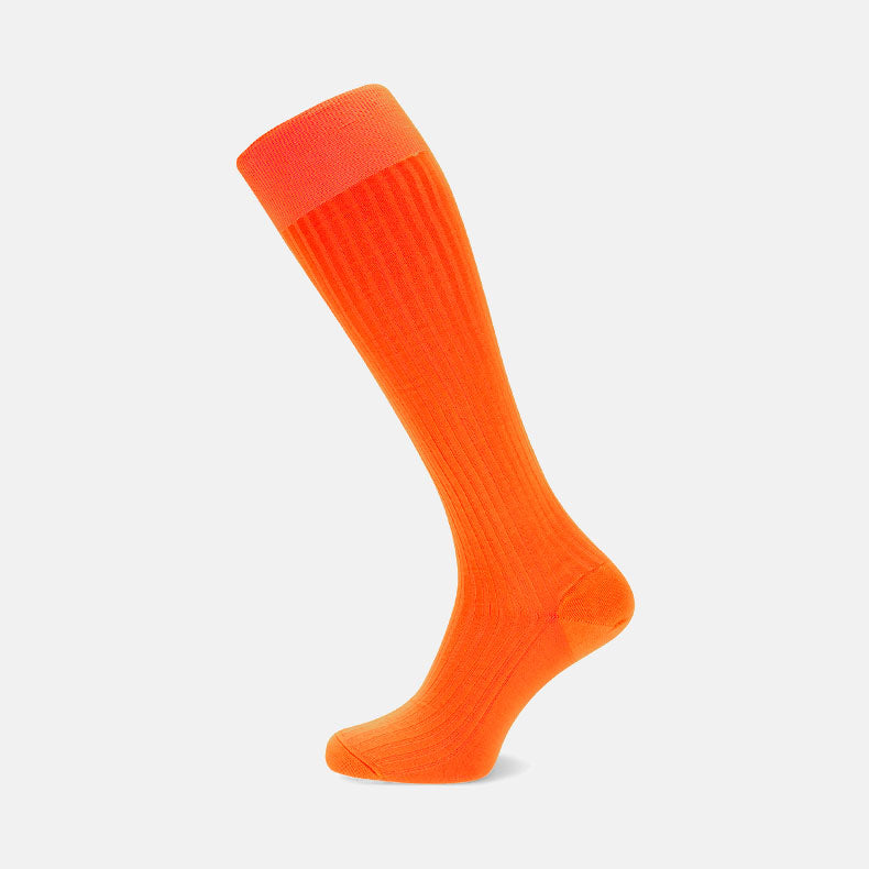 View 1 of product Turnbull & Asser Orange Long Cotton Sock, featuring a ribbed texture and luxury men’s style, is shown as a single knee-high sock against a plain white background.