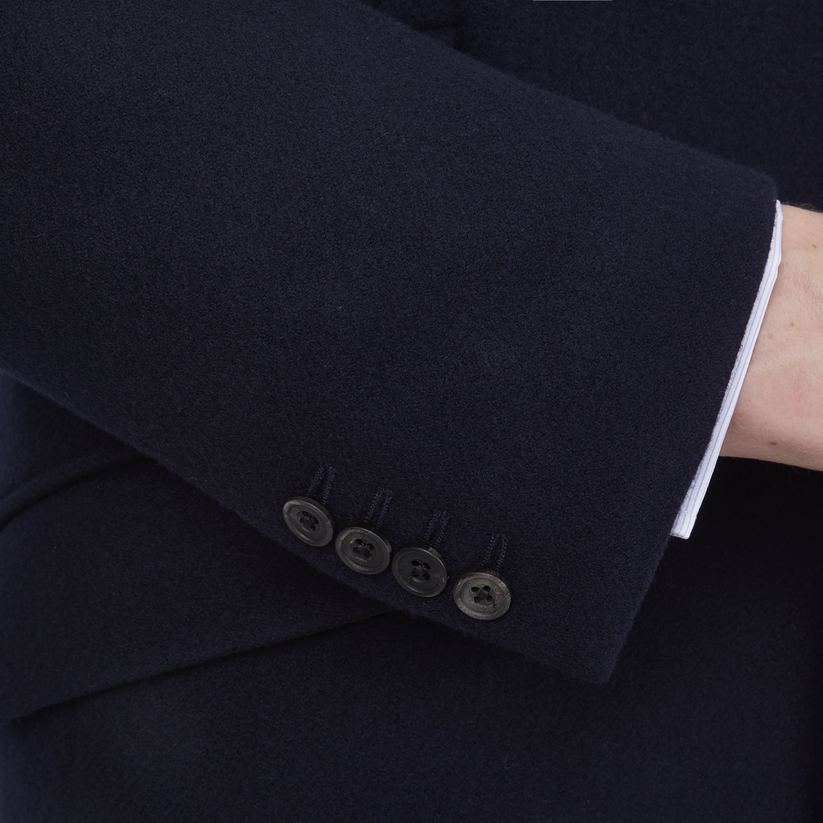 View 4 of product The Turnbull & Asser Navy Lambswool Joseph Overcoat, a men's knee-length coat with notched lapels, a single-breasted front, and three flap pockets per side, is shown against a plain white background.