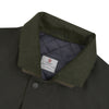 View 6 of product The Turnbull & Asser Dark Green Waxed Cotton Field Coat features a straight fit, button-up front, two large bottom flap pockets, slanted chest pockets, and a contrasting collar. Shown against a plain white background.