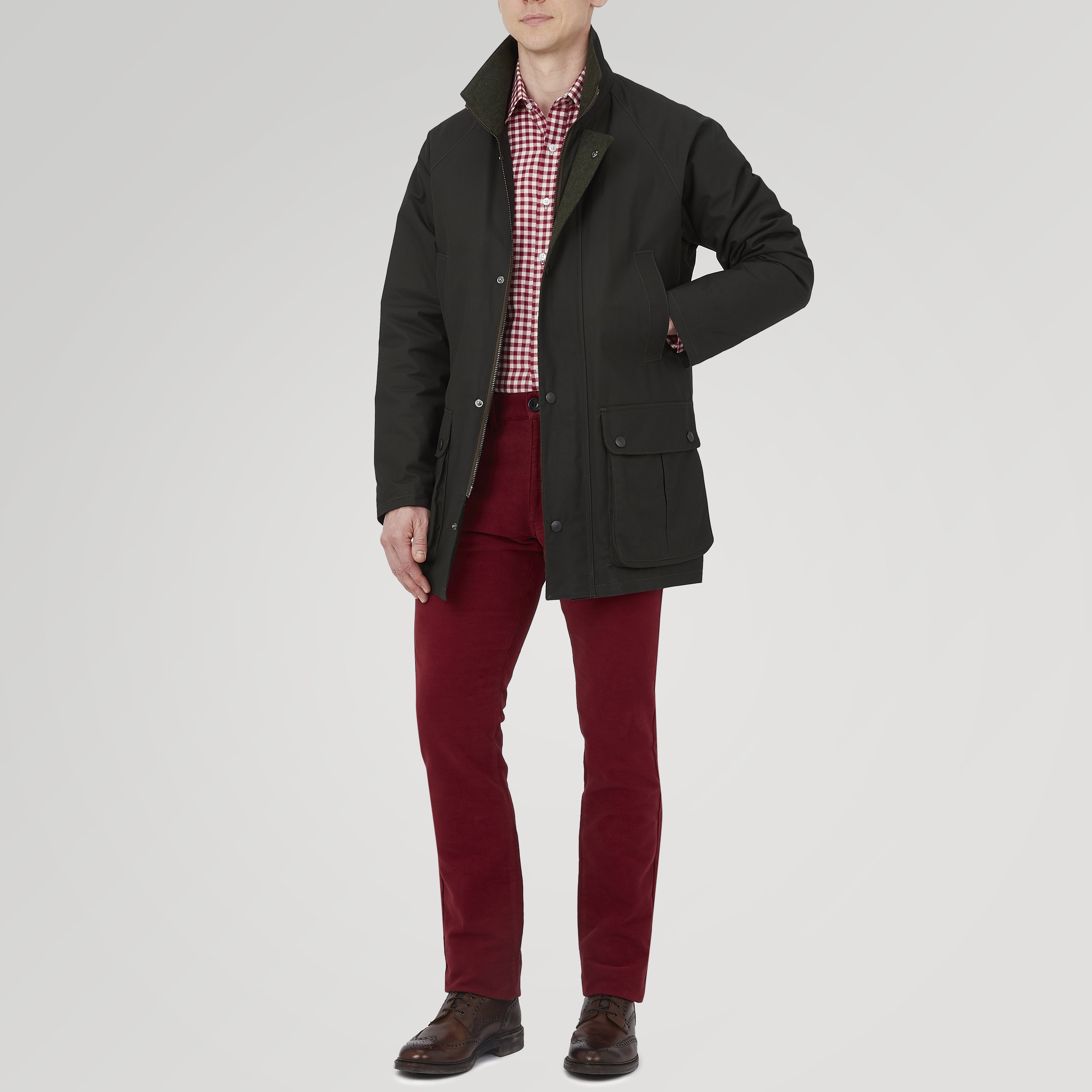 View 2 of product The Turnbull & Asser Dark Green Waxed Cotton Field Coat features a straight fit, button-up front, two large bottom flap pockets, slanted chest pockets, and a contrasting collar. Shown against a plain white background.