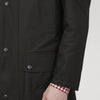 View 5 of product The Turnbull & Asser Dark Green Waxed Cotton Field Coat features a straight fit, button-up front, two large bottom flap pockets, slanted chest pockets, and a contrasting collar. Shown against a plain white background.