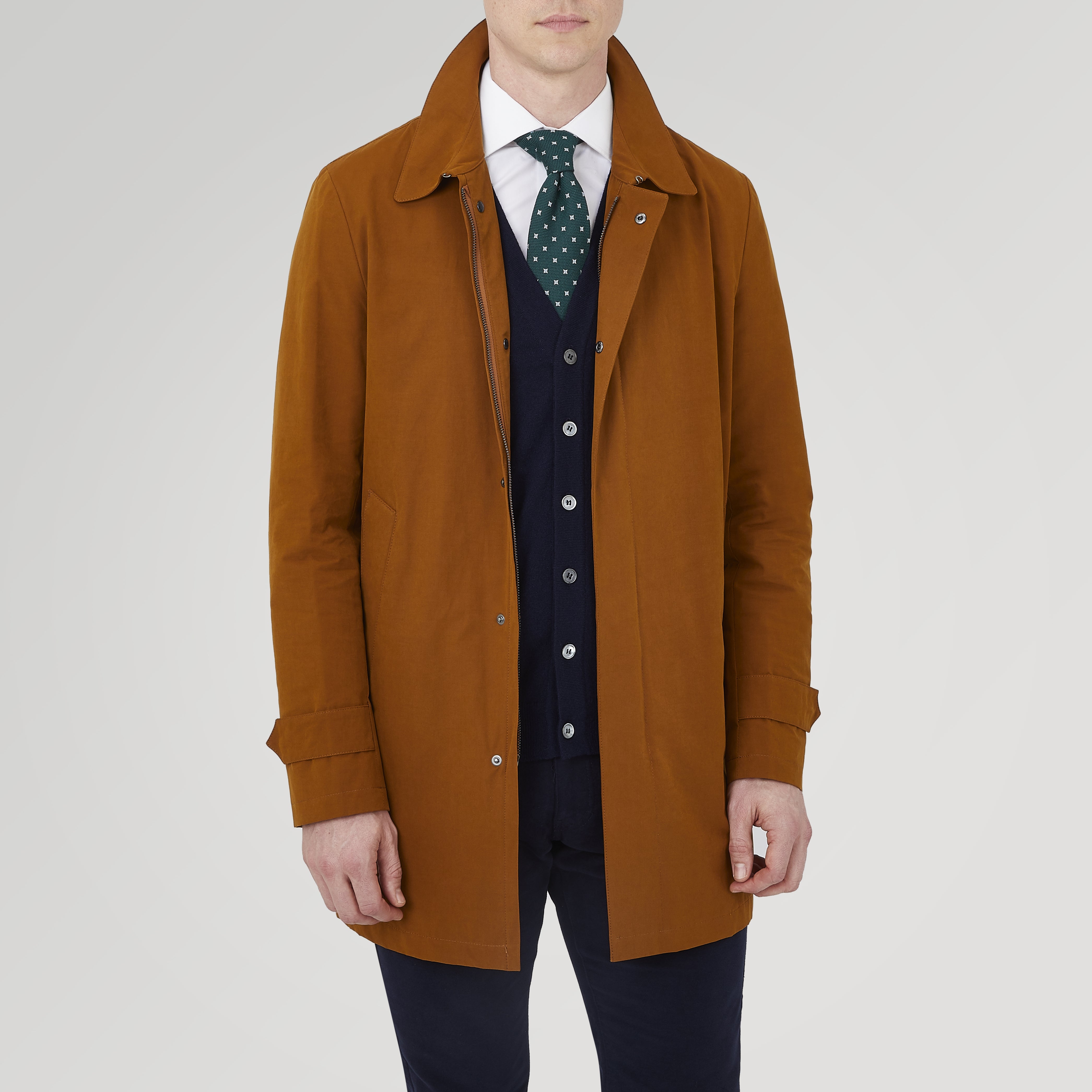 View 2 of product The Turnbull & Asser Dark Khaki Cotton Car Coat features a classic collar, long sleeves, front welt pockets, tailored fit, and concealed button closure in a knee-length modern design, shown against a plain white background.