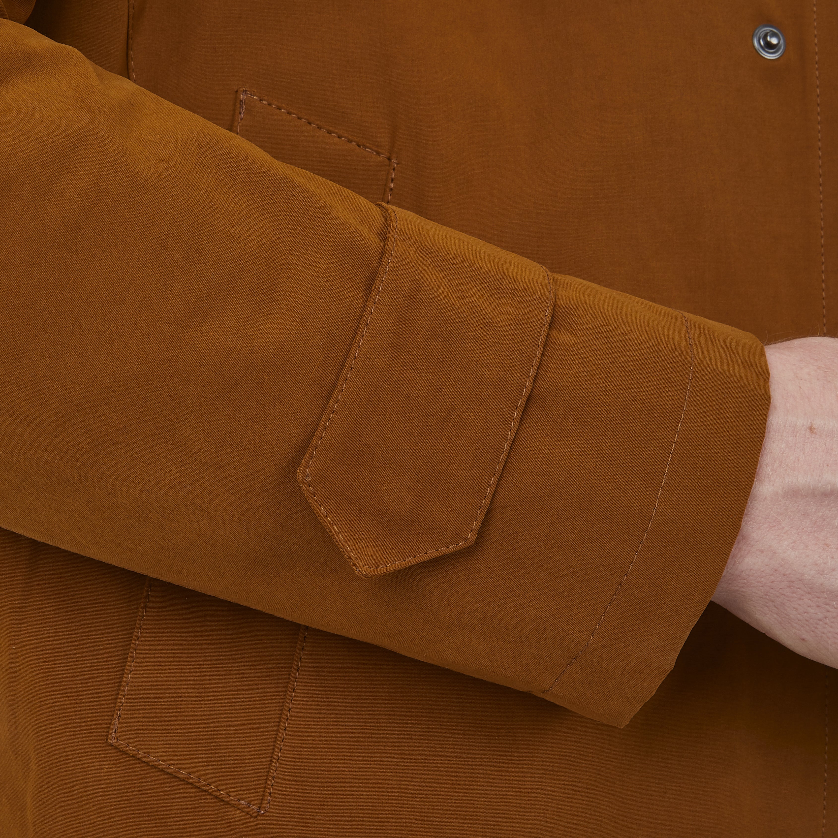 View 4 of product The Turnbull & Asser Dark Khaki Cotton Car Coat features a classic collar, long sleeves, front welt pockets, tailored fit, and concealed button closure in a knee-length modern design, shown against a plain white background.