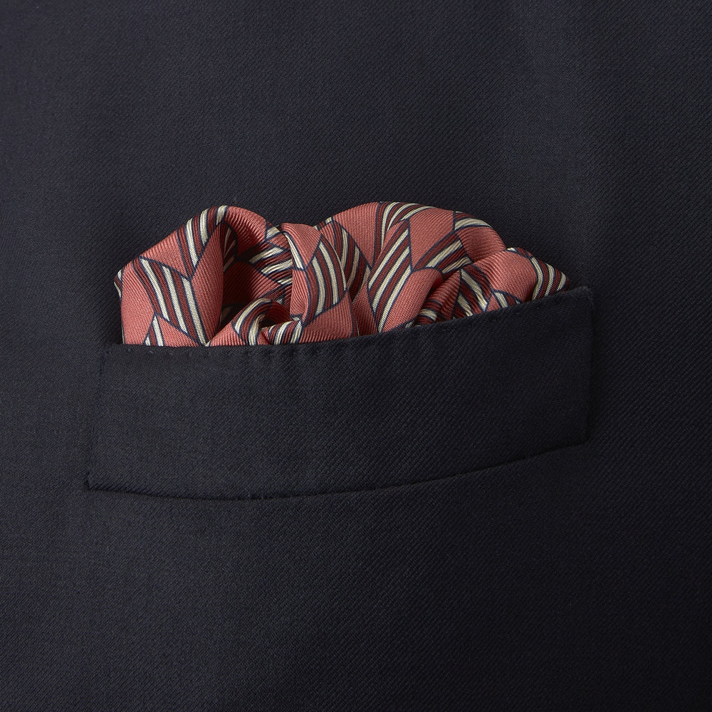 The Turnbull & Asser Red and Pink Arrow Silk Pocket Square features a striking pattern and luxurious silk, perfect for adding elegance to any look.
