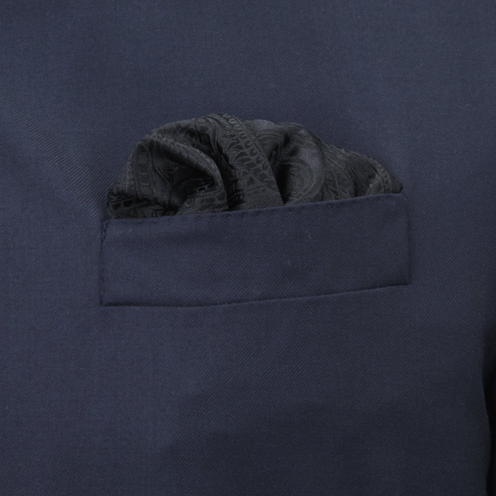 View 4 of product The Turnbull & Asser Black House Paisley Hand-Rolled Silk Pocket Square is elegantly folded to showcase both sides—a refined accessory, ideal for black tie attire.