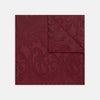 View 1 of product The Turnbull & Asser Burgundy House Paisley Hand-Rolled Silk Pocket Square features elegant paisley silk, expertly hand-rolled edges, and a classic fold—ideal for elevating black tie attire.