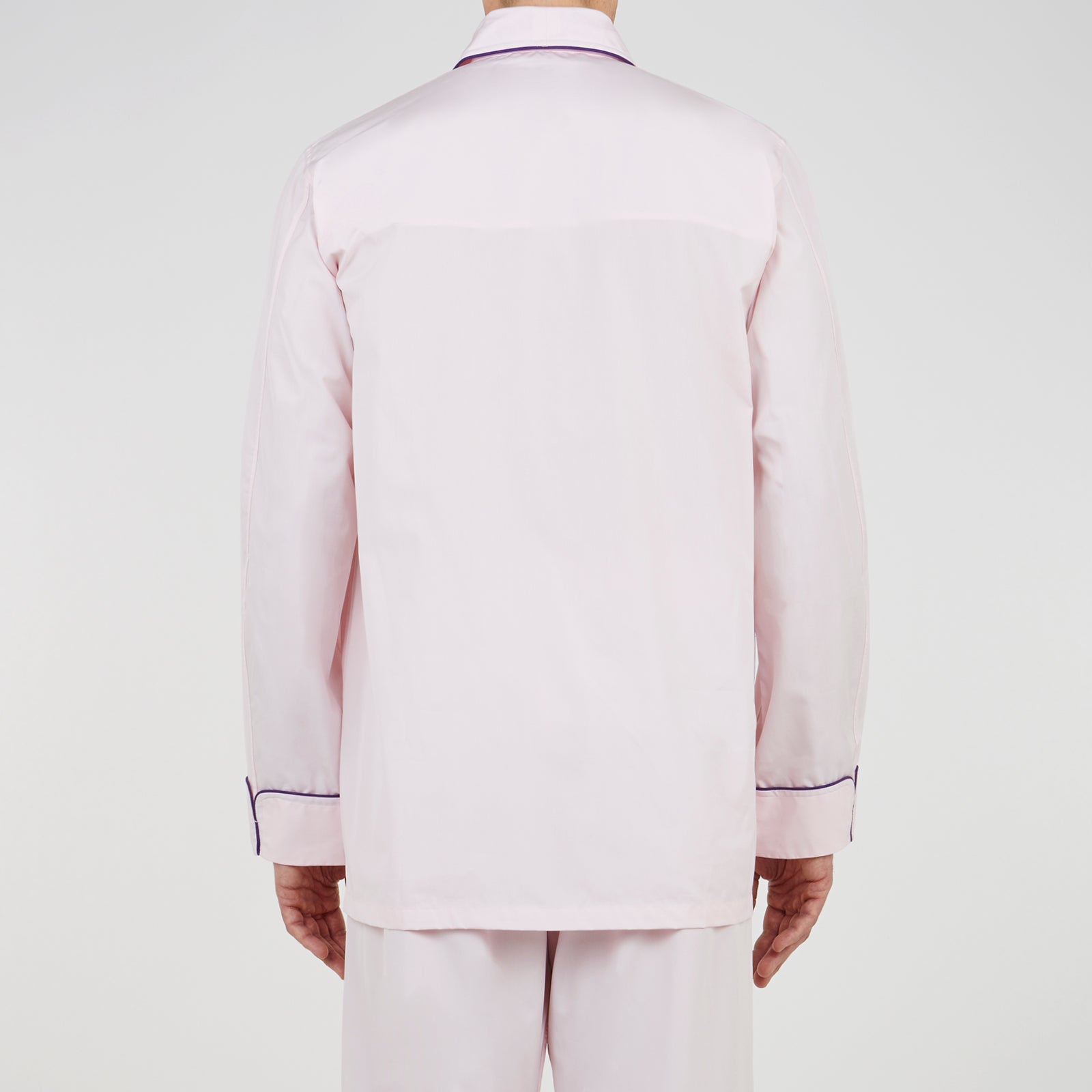 View 3 of product The Turnbull & Asser Pink Piped Cotton Pyjama Set, featuring dark piping on the collar and front with matching pants, is elegantly displayed on a white background—a luxurious sleepwear choice.