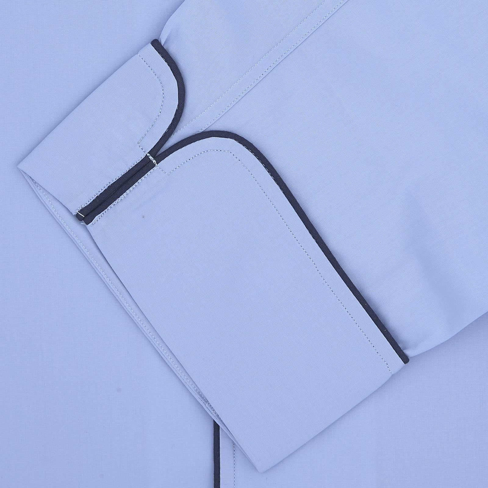 View 2 of product The Blue Piped Cotton Pyjama Set by Turnbull & Asser features light blue cotton, dark piping, white buttons, and a matching fabric belt—a luxurious men's sleepwear choice, shown on a plain white background.