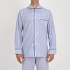 View 2 of product The Turnbull & Asser Blue Bengal Stripe Piped Cotton Pyjama Set, featuring a folded top with white buttons beside matching bottoms, is displayed on a plain light background.
