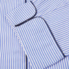 View 4 of product The Turnbull & Asser Blue Bengal Stripe Piped Cotton Pyjama Set, featuring a folded top with white buttons beside matching bottoms, is displayed on a plain light background.