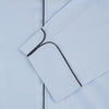 View 2 of product The Light Blue Piped Sea Island Quality Cotton Pyjama Set by Turnbull & Asser, shown with a matching face mask, features dark piping and is crafted from premium cotton, all displayed on a plain white background for a luxurious look.