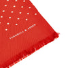 View 2 of product The Red and White Spotted Silk Scarf by Turnbull & Asser features white polka dots and fringed edges on silk. The brand name appears subtly on one end, with the scarf displayed against a plain light background.