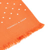 View 2 of product The Turnbull & Asser Orange and White Spotted Silk Scarf, featuring white polka dots and fringed edges, is neatly folded and displayed on a plain light gray background.